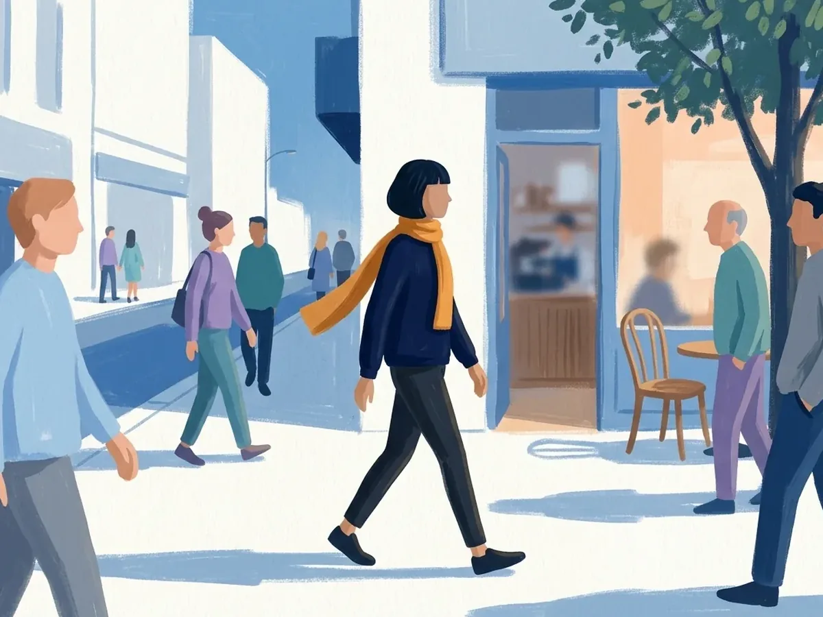 In morning light, the same person walks right along a sunlit pavement, amber scarf lifting behind them, past people and a café with its door open, under a leafy tree.