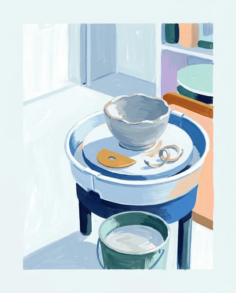 A wet clay bowl with an uneven rim sits on a potter's wheel beside a wooden rib, trimmed clay, and a slip bucket.